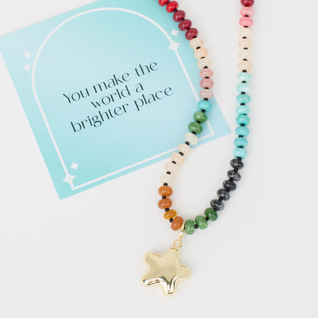 A flat lay of jBloom jewelry pieces